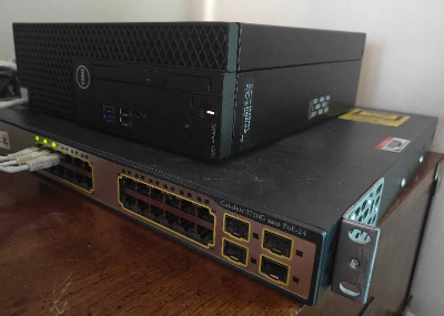 An image of a dell optiplex 3060 computer above a Cisco Catalyst 3750G network switch